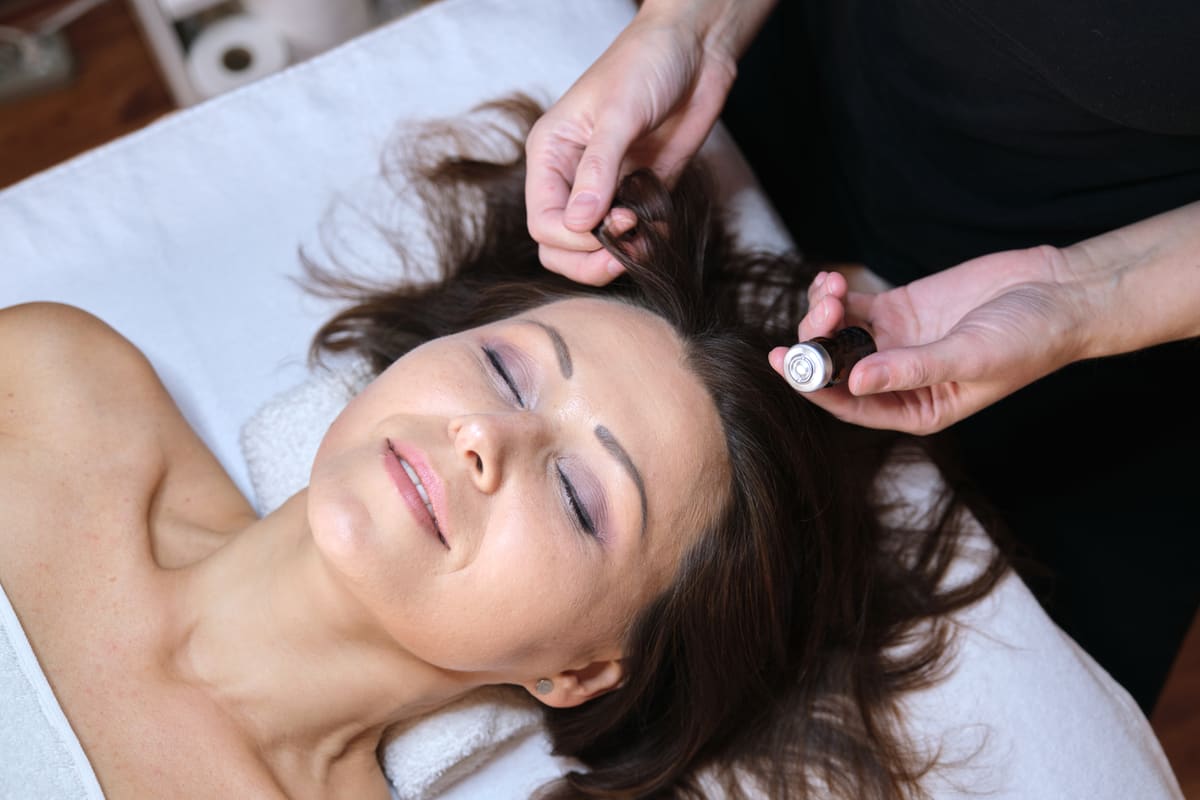 Microneedling treatment being performed on a client’s scalp