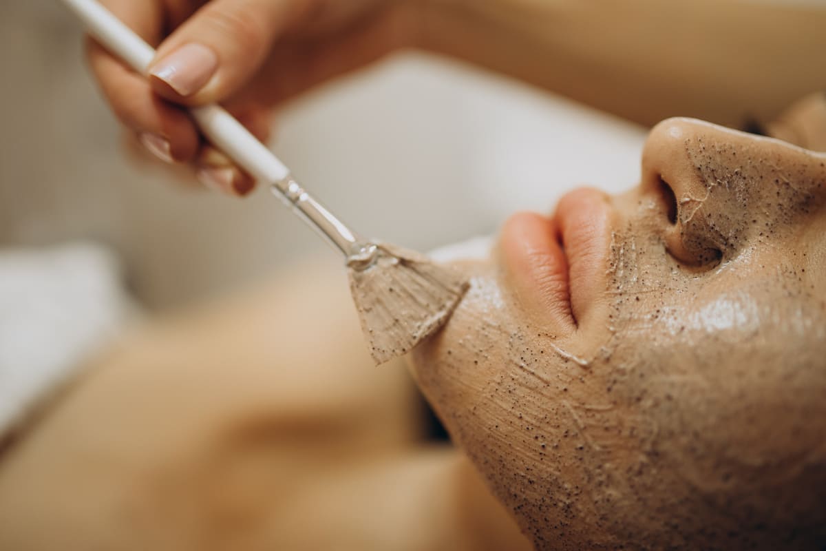 Mask being applied with a brush during a lifting facial